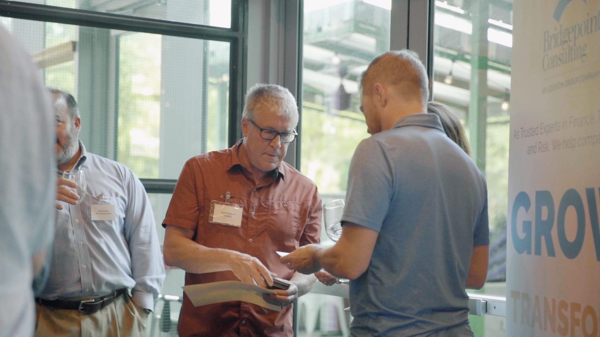 Businessmen exchanging business cards at a Bridgepoint event