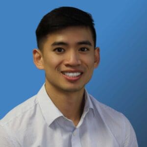 Headshot of Bridgepoint Consultant Van Bui over a blue background