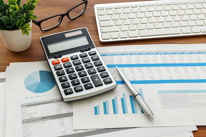 Financial accounting with calculator and financial chart data and computer keyboard