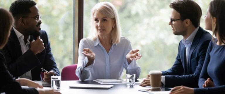 CFO in a conference room with her team discussing SEC reporting requirements.