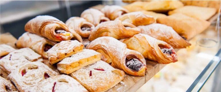 Zoomed-in view of multiple pastries on a bakery stand